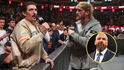 Andrew Schulz poses with Triple H after his physical confrontation with Logan Paul on WWE Raw