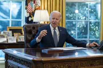 Biden defends record in raspy-voiced final interview